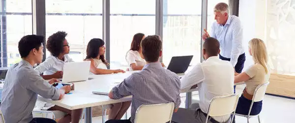 healthcare board team discussing in a meeting room about Scaling Up a Physician Education Program Led to Efficiencies for a Large Health System