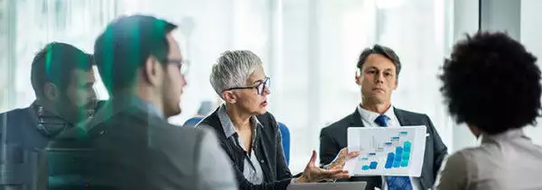 healthcare board team discussing in a meeting room about Improved Compliance Strengthens Business