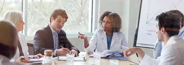 Healthcare team discussing care coordination in a meeting room