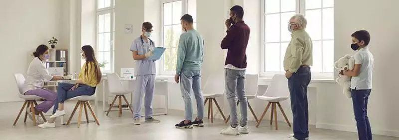 Patients lining up for a doctor's checkup in a clinic