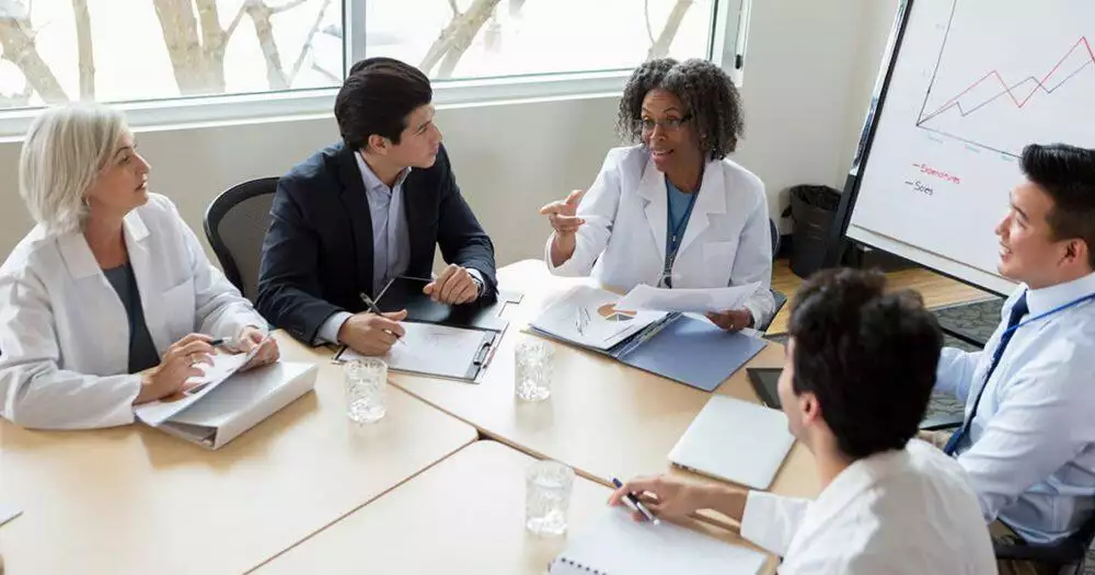 Doctors and healthcare professional having a meeting around a table