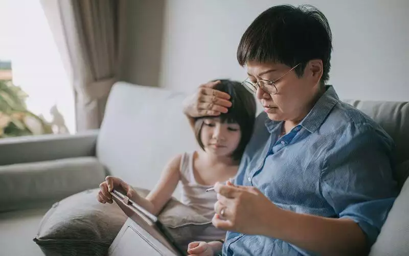 A mother bonding with her child in a sofa at home